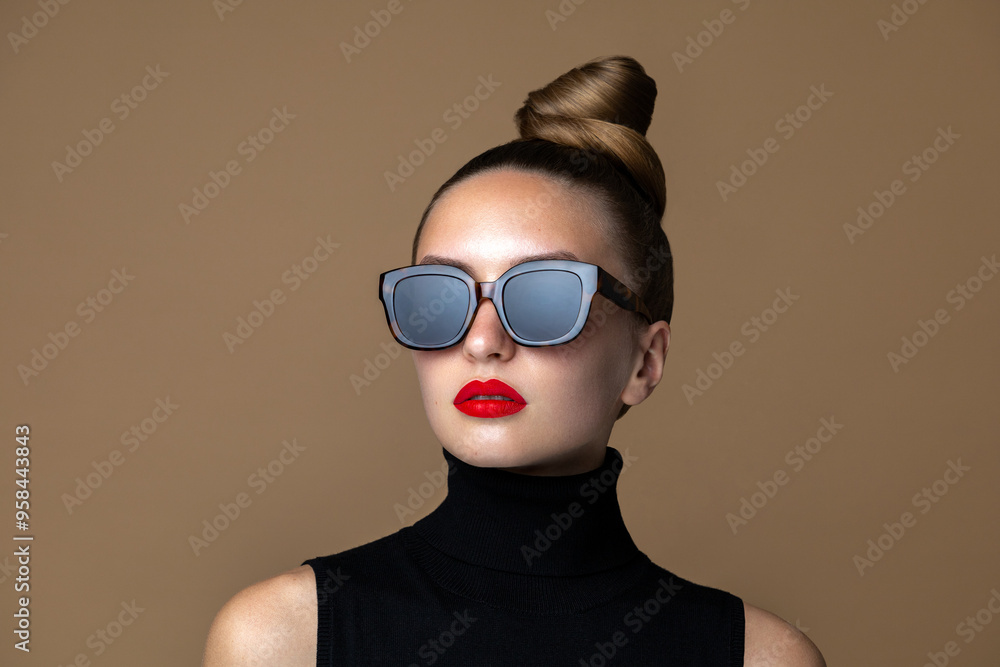 Eye wear fashion. Beauty portrait of glamour model posing in the black square shape classic sunflasses with bold make up. Eye wear fashion. Beauty portrait of glamour model posing in the black square shape classic sunflasses with bold make up.