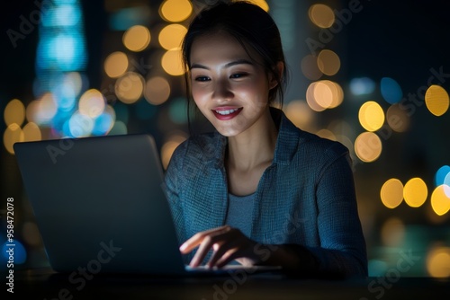 Against the backdrop of a high-tech ambiance dazzled with colorful lights and vivid technology effects, a young woman technologist sits. Stock photo.