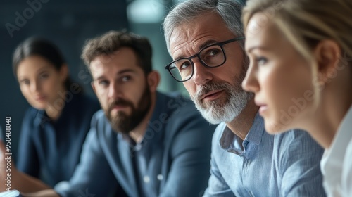 Group of executives discussing collaborative strategy for business objectives, showcasing clear facial expressions