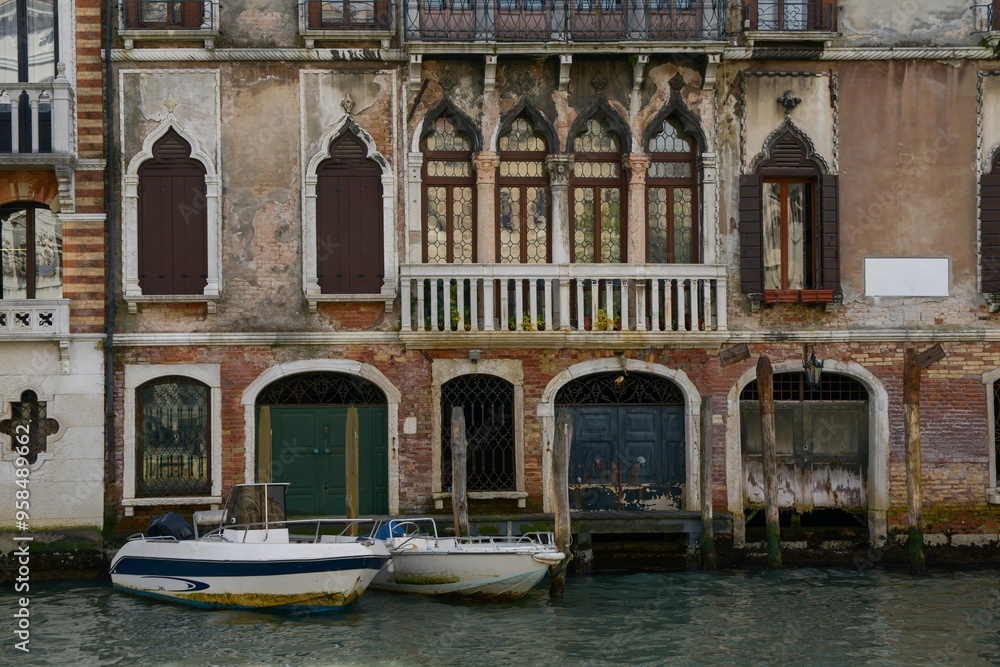Weathered building facade with boats in Venice, Italy Weathered building facade with boats in Venice, Italy