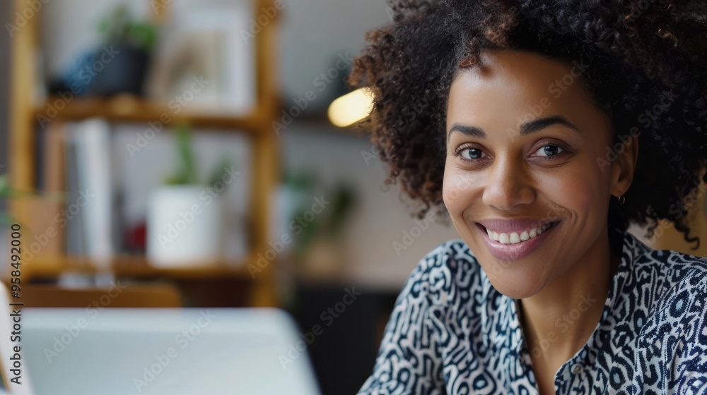 Business communication via video chat, with a woman smiling and taking notes Business communication via video chat, with a woman smiling and taking notes