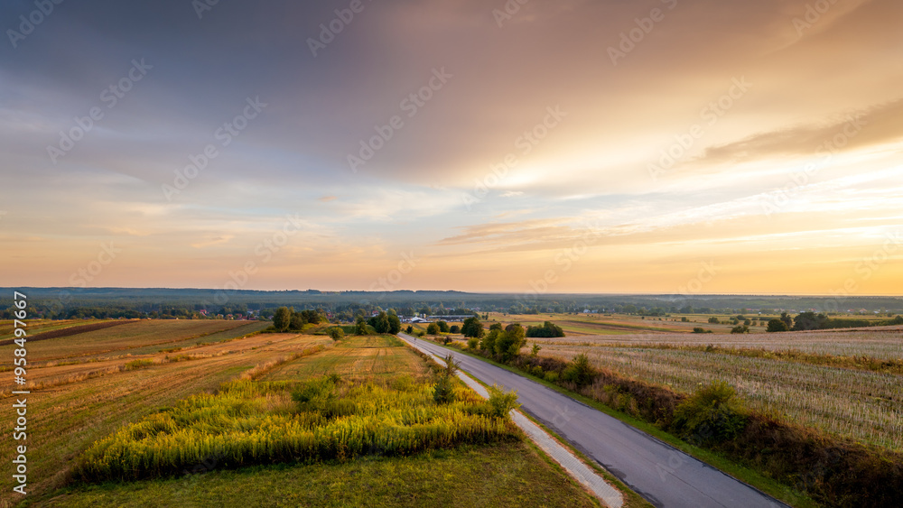 Beautiful landscape. Colorful sky, road and fields. Forests in the distance. View from the observation tower. .Susiec, Roztocze, Poland
