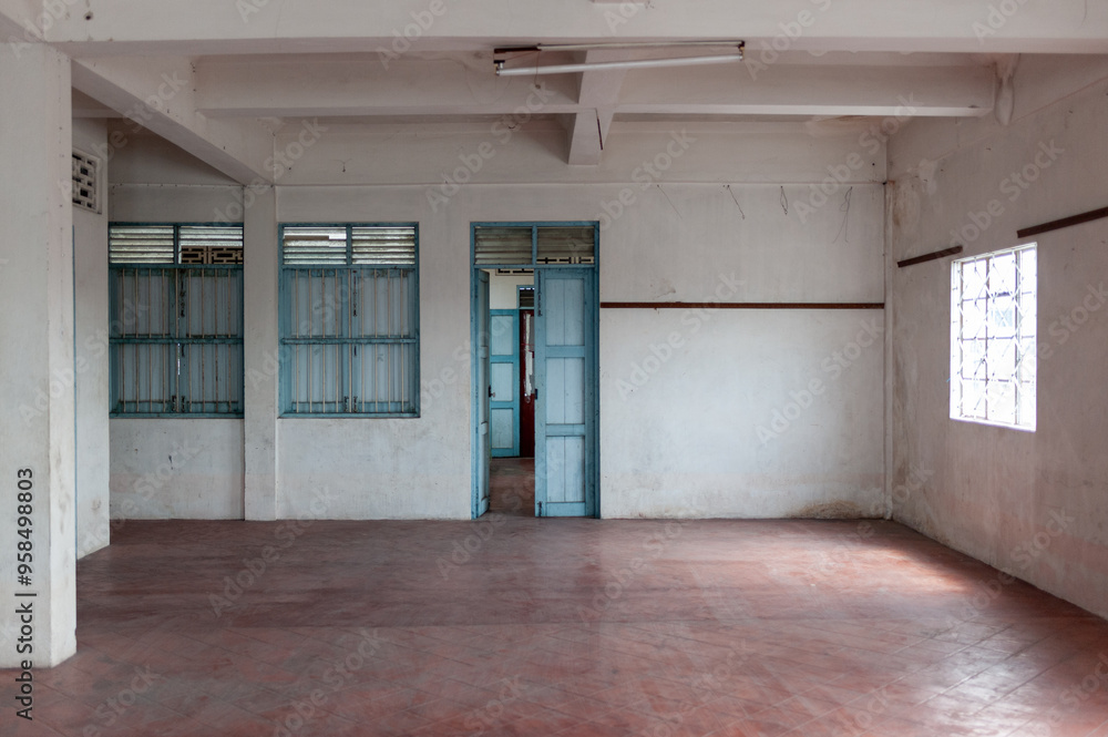 Fototapeta premium Spacious empty room with white walls and blue doors, perfect for various creative projects or interior design inspiration.