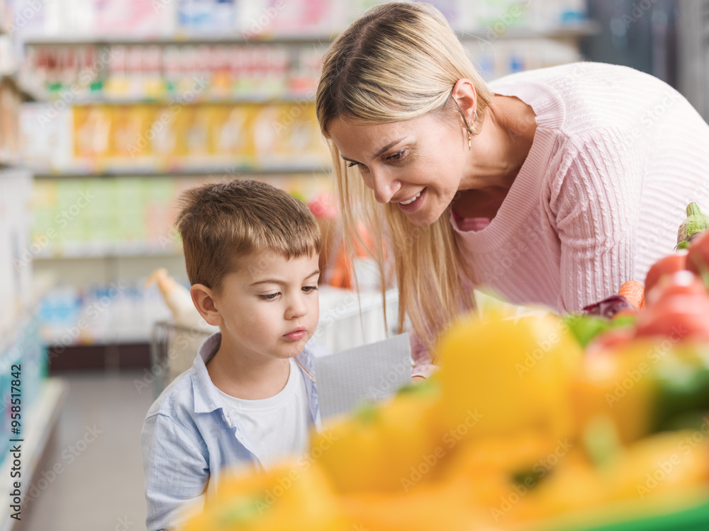 Obraz premium Mother showing the grocery list to her son