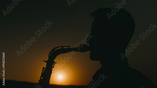A stunningly beautiful silhouette of a saxophonist performing against a breathtaking sunset backdrop, captivating all