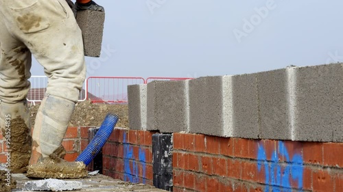 Building a Sturdy Foundation With Brick and Concrete Blocks in Sunny Outdoor Construction Site photo