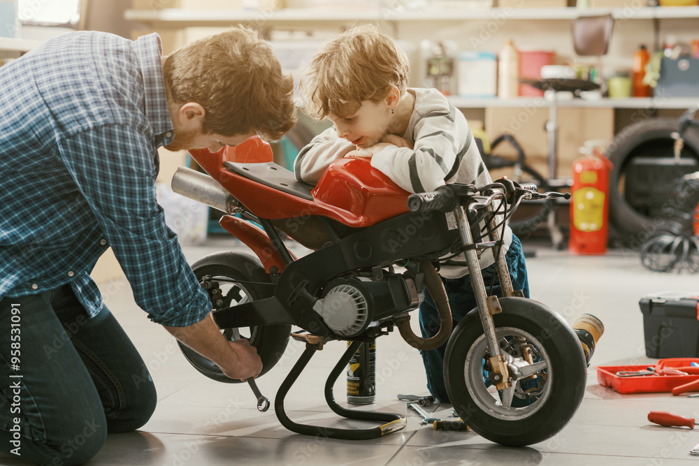 Father checking the son's motorbike in the garage Father checking the son's motorbike in the garage