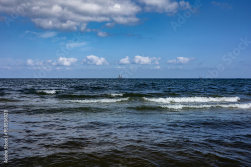 Landscape with beautiful wavy Baltic sea and blue sky in Sopot, Poland. 