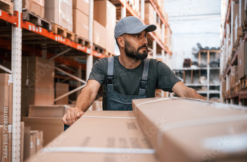 Moving the products in boxes. Foreman is in the storehouse, shipping distribution business