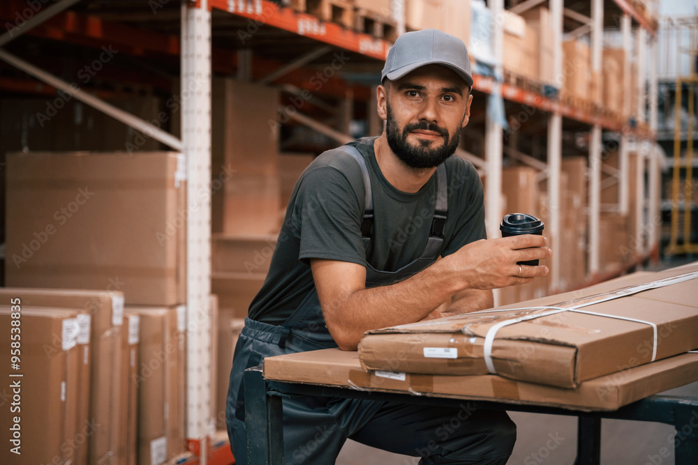 In cap, with boxes. Foreman is in the storehouse, shipping distribution business In cap, with boxes. Foreman is in the storehouse, shipping distribution business