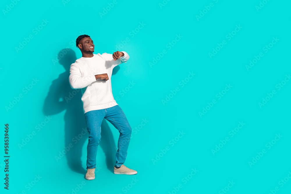 Full body photo of attractive young man dance enjoy discotheque dressed stylish white clothes isolated on cyan color background Full body photo of attractive young man dance enjoy discotheque dressed stylish white clothes isolated on cyan color background