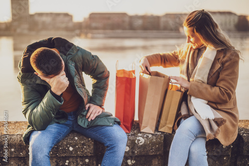 Husband is angry because his wife has spent too much money on shopping.	