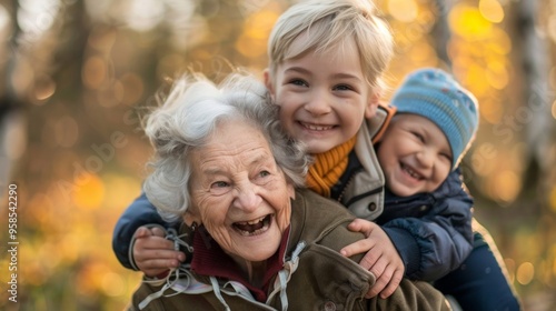 Happy grandmother with grandsons, all smiling in warm jackets and hats, symbolizing strong family bonds in a cozy autumn park setting.