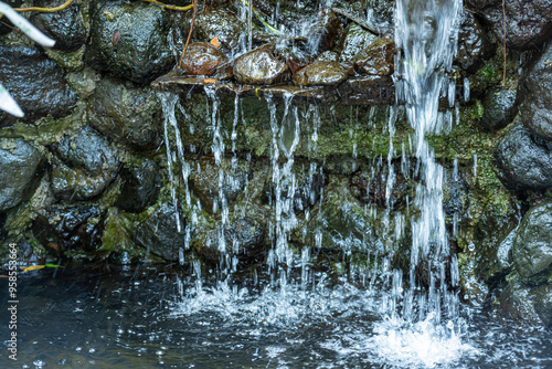 Waterflow from the rocks in a garden-style restaurant, similar to a mini waterfall photo