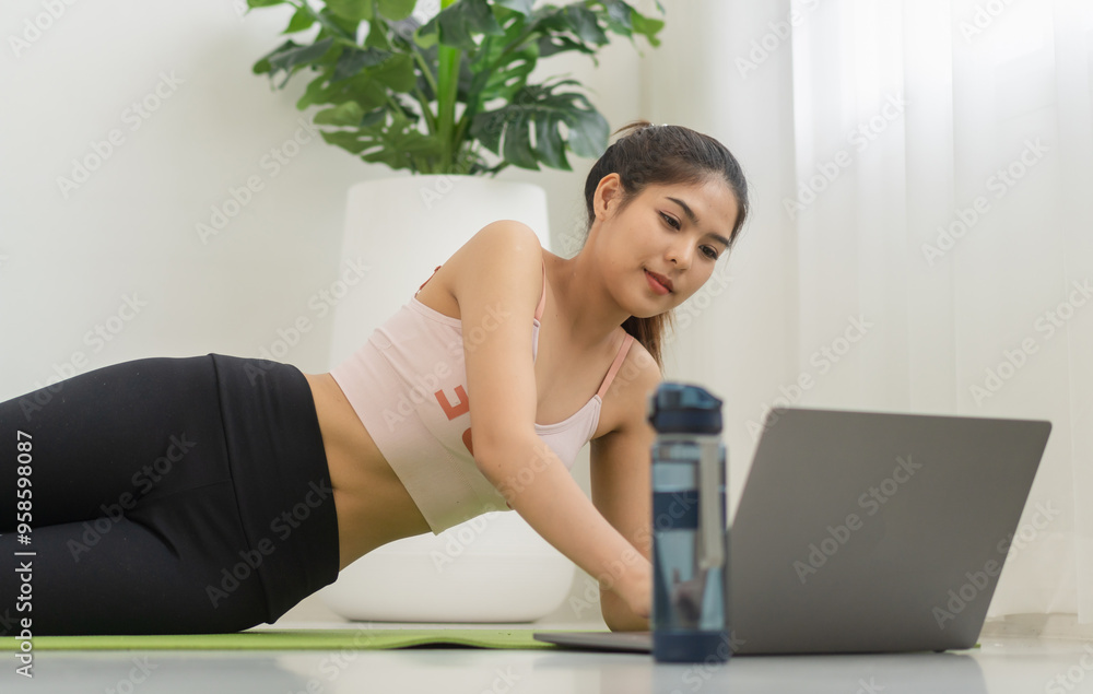 Portrait of sport slim fit strength asian woman training in sportswear relax and practicing yoga, fitness, exercise, wellness, workout, sport at home.Diet concept.Fitness and healthy lifestyle Portrait of sport slim fit strength asian woman training in sportswear relax and practicing yoga, fitness, exercise, wellness, workout, sport at home.Diet concept.Fitness and healthy lifestyle