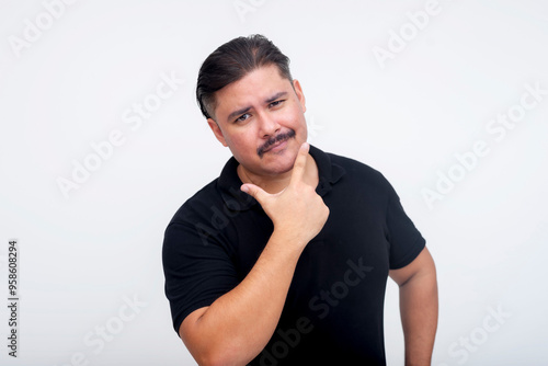 A stocky middle aged man with a mustache and of mixed race bragging about his looks while looking cocky. Set against a white background.