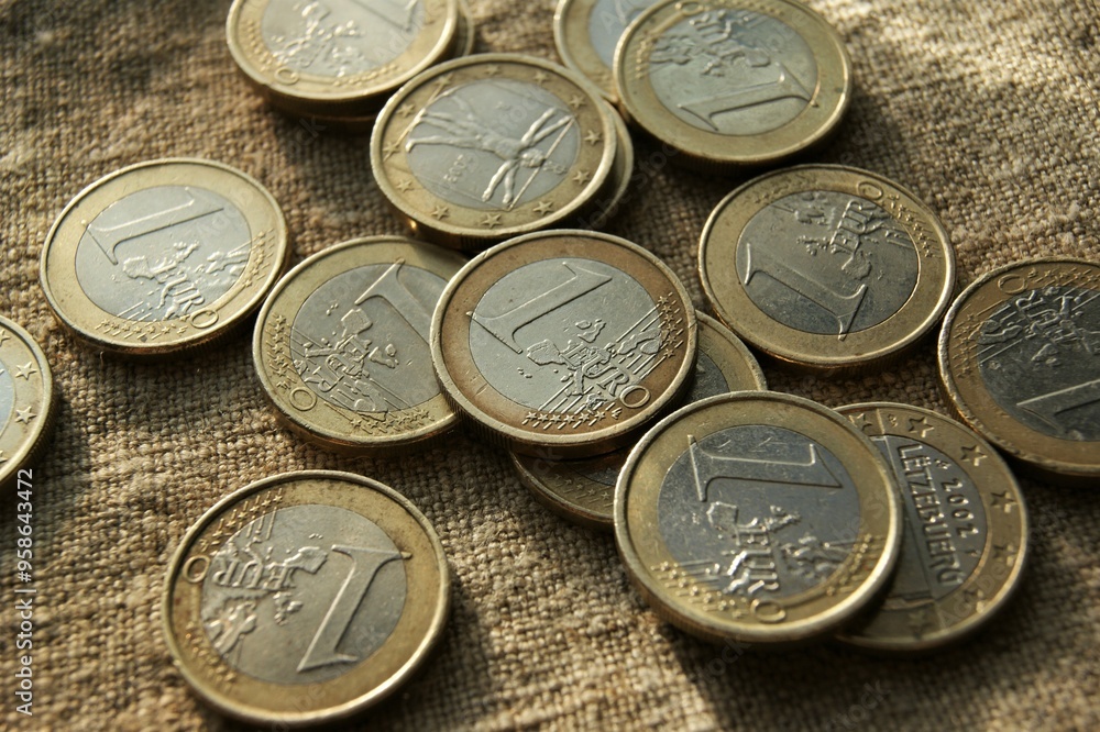 European money. Poured 1 Euro coins on natural linen fabric. European money. Poured 1 Euro coins on natural linen fabric.