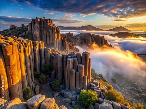 Misty dawn breaks over rugged Rumorosa basalt columns in Baja California, Mexico, casting an ethereal glow on the photo