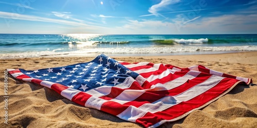 Patriotic swimsuit featuring stars and stripes design, draped over a beach towel on a sun-kissed sandy shore, photo