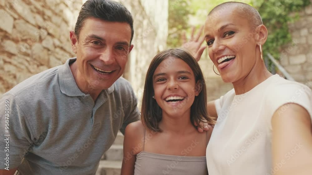 Happy young family of three smiling while spending time together and taking selfie Happy young family of three smiling while spending time together and taking selfie