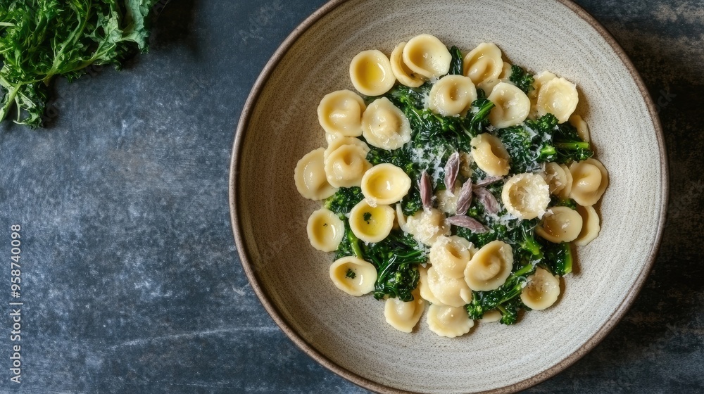 An artistic presentation of orecchiette pasta with broccoli rabe, anchovies, and garlic, served in a minimalist style. - An artistic presentation of orecchiette pasta with broccoli rabe, anchovies, and garlic, served in a minimalist style. -