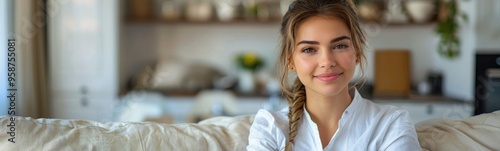 Smiling woman sitting on a couch with her arms crossed, portrait, banner, copy space