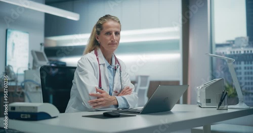 Wallpaper Mural Expert Female Physician Works on a Laptop in a Hospital Office, Focusing on Patient Data Analysis and Medical Research in an Advanced Clinical Setting. Zoom in Turning and Looking at Camera Torontodigital.ca