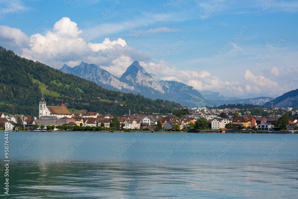 small old town on the coast of the lake with mountain peaks in the background small old town on the coast of the lake with mountain peaks in the background