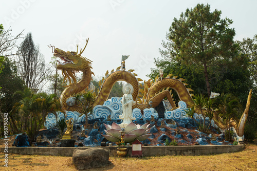 THA TON, CHIANG MAI, THAILAND - MARCH 2020: The giant dragon fountain is surrounded by rainforest. Wat Tha Ton (Phra Aram Luang) is a famous Buddhist complex in the north of Thailand  photo