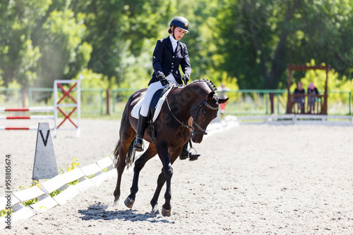 Young equestrian girl performing her dressage test in equestrian competition