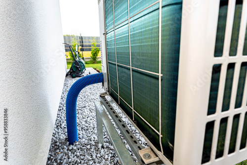 Fotografi Two efficient outdoor heat pump units placed in front of the house