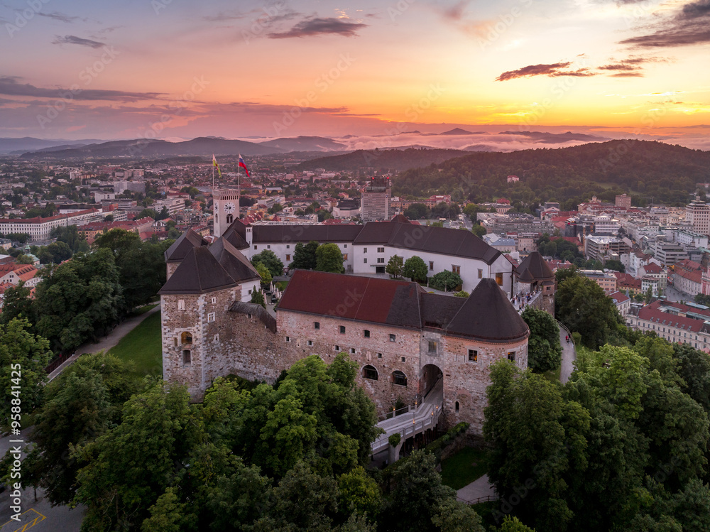 Fototapeta premium Aerial sunset view of Ljubljana castle and city with pentagonal bastion, Archer's tower, courtyard in the Slovenian capital