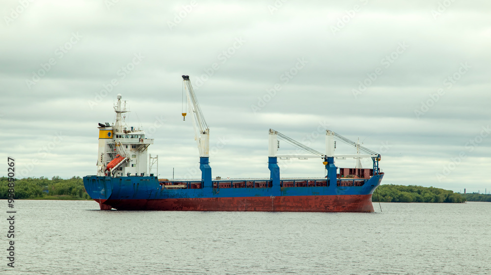 A large cargo sea vessel is at anchor, a dry cargo ship is at anchor A large cargo sea vessel is at anchor, a dry cargo ship is at anchor