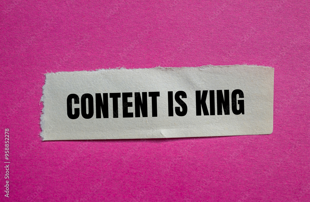 Content is king message written on ripped torn paper piece with pink background. Conceptual content is king symbol. Copy space. Content is king message written on ripped torn paper piece with pink background. Conceptual content is king symbol. Copy space.