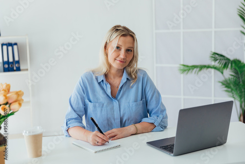 woman blonde working in office online internet on laptop