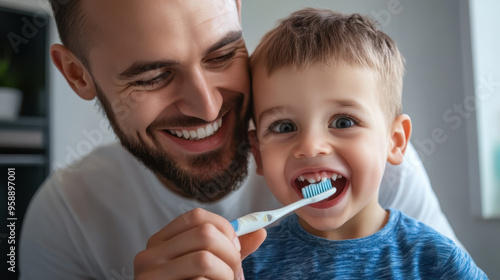 Dad and son brush their teeth with a toothbrush in bathroom interior. Concept of daily dental care, oral hygiene, raising children, good habits, father's day