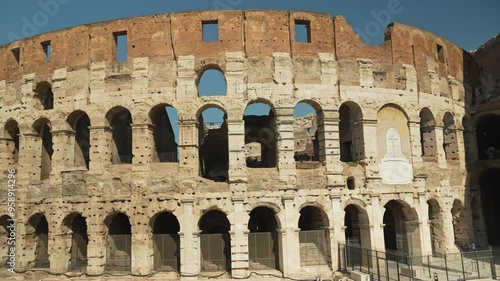 Crowd of tourists strolls near the Roman Coliseum or Flavian Amphitheatre. Amphitheatrum Flavium or Colosseo. Sightseeing in Italy of ancient Rome photo