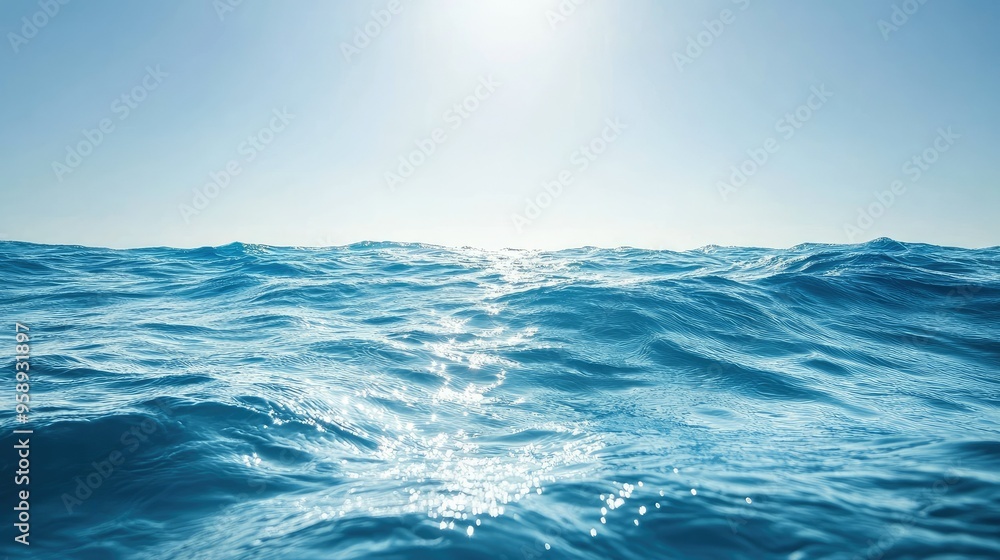 Deep blue ocean waves under a clear sky, sunlight reflecting on the water surface Deep blue ocean waves under a clear sky, sunlight reflecting on the water surface