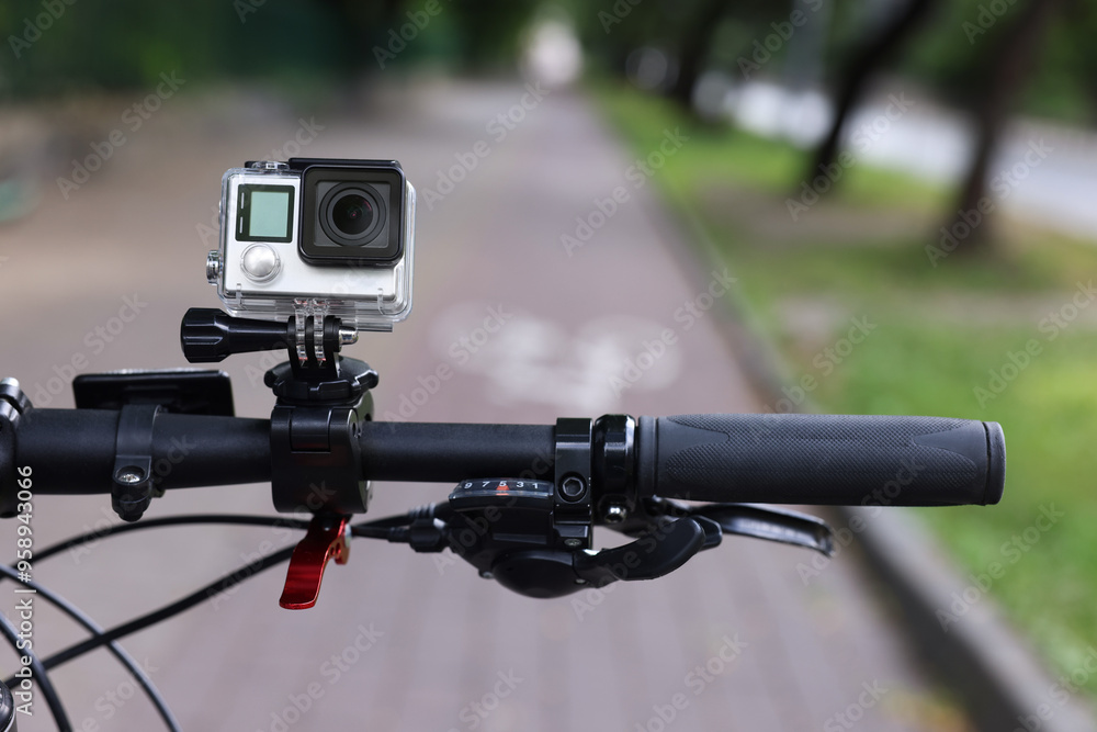 Modern action camera with mount on bicycle outdoors, closeup Modern action camera with mount on bicycle outdoors, closeup
