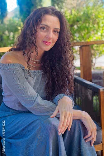 Woman in Gray Outfit Relaxing on a Wooden Deck with Yellow Shoes