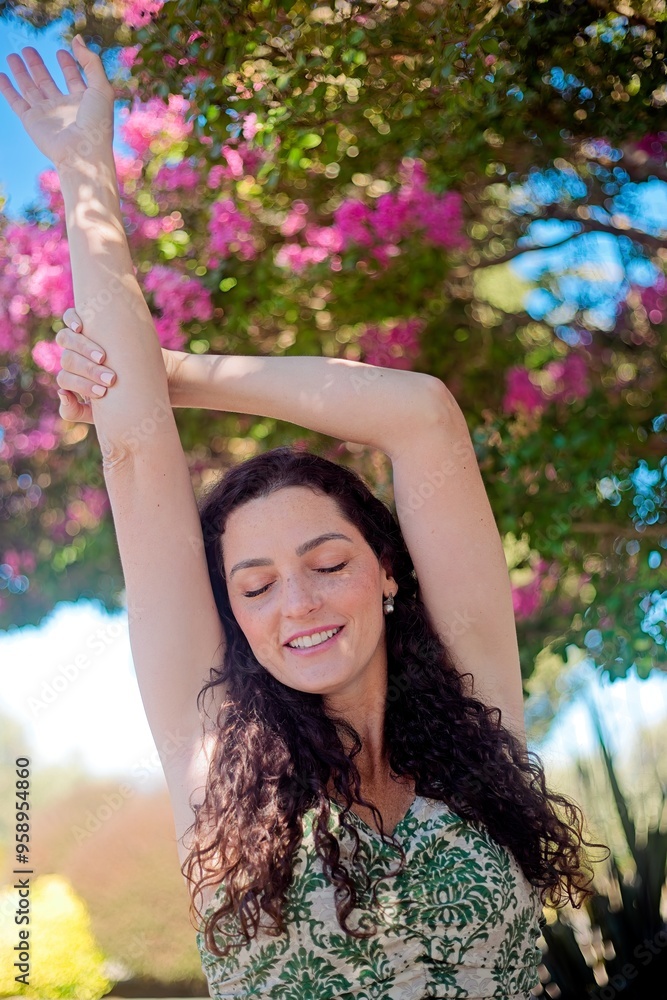 Woman Admiring Pink Flowers on a Sunny Day Woman Admiring Pink Flowers on a Sunny Day