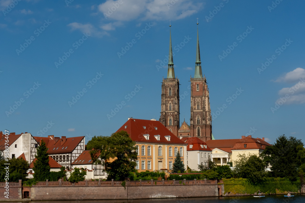 Naklejka premium Towers of the ancient church in the sunset sun on a sunny summer day in Wroclaw, Poland. High quality photo