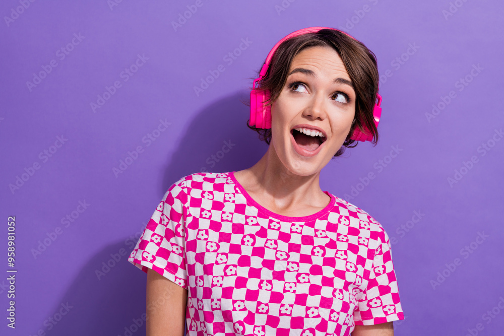 Photo of cute cheerful positive glad girl wear pink trendy clothes buy modern device headphones isolated on purple color background Photo of cute cheerful positive glad girl wear pink trendy clothes buy modern device headphones isolated on purple color background