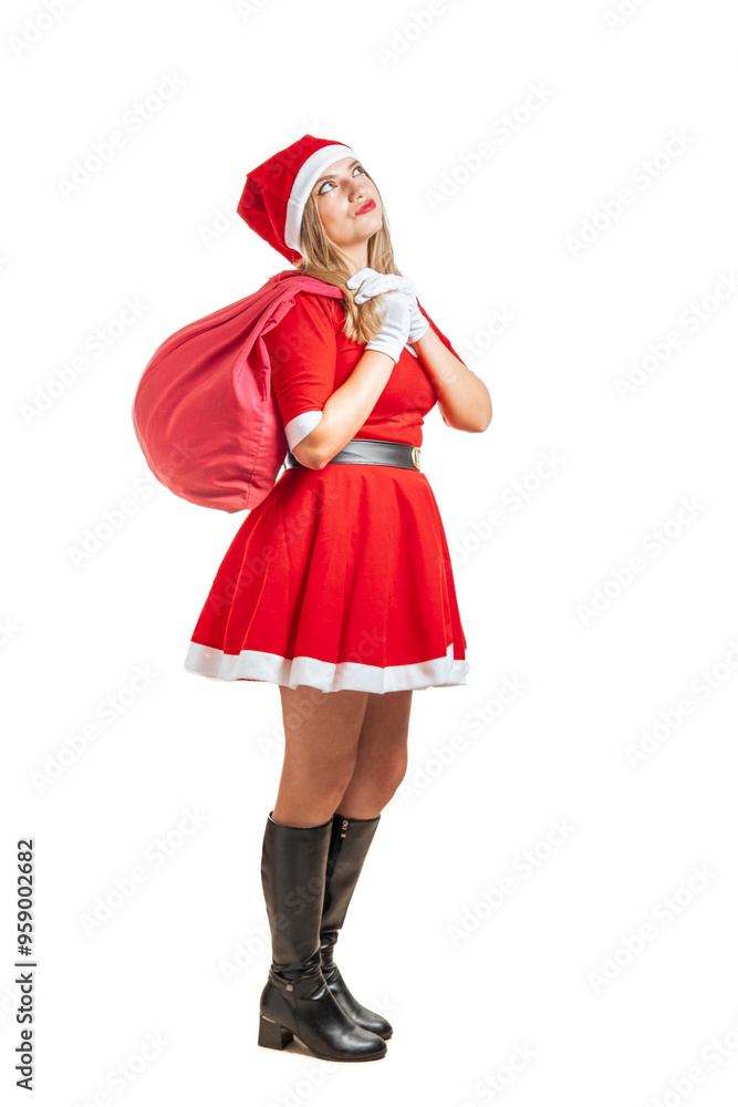 Young blonde woman Santa Claus walking thoughtfully with a bag of gifts at Christmas Young blonde woman Santa Claus walking thoughtfully with a bag of gifts at Christmas