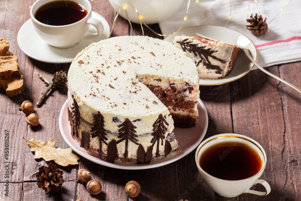 Tea party with Black Forest cake. Cherry cake decorated with chocolate fir trees on a light background.
