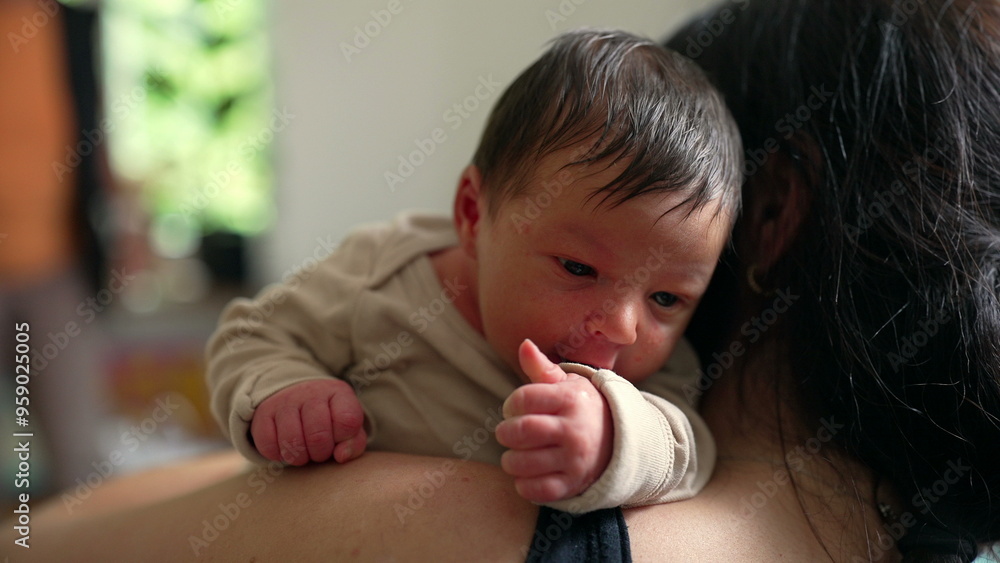Newborn baby on parent's shoulder, gazing curiously. The intimate moment is filled with love and warmth, capturing the bond and security the baby feels in the parent's arms Newborn baby on parent's shoulder, gazing curiously. The intimate moment is filled with love and warmth, capturing the bond and security the baby feels in the parent's arms