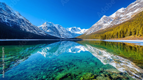 a pristine Canadian wilderness lake reflecting snow-capped mountains