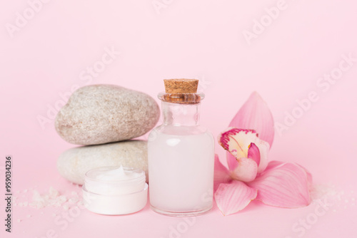 Composition with orchids, spa products on color background