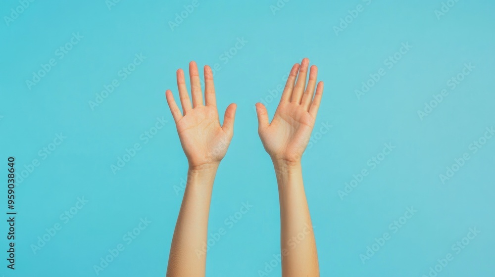 Obraz premium Raised Hands on Blue Background