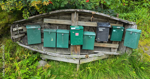 The post boxes in rural Norway hidden in old wooden boat photo